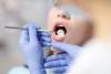 female dentist checking patient girl teeth