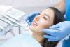 Young Female patient with pretty smile examining dental inspection at dentist clinic. Healthy teeth and medicine, stomatology concept